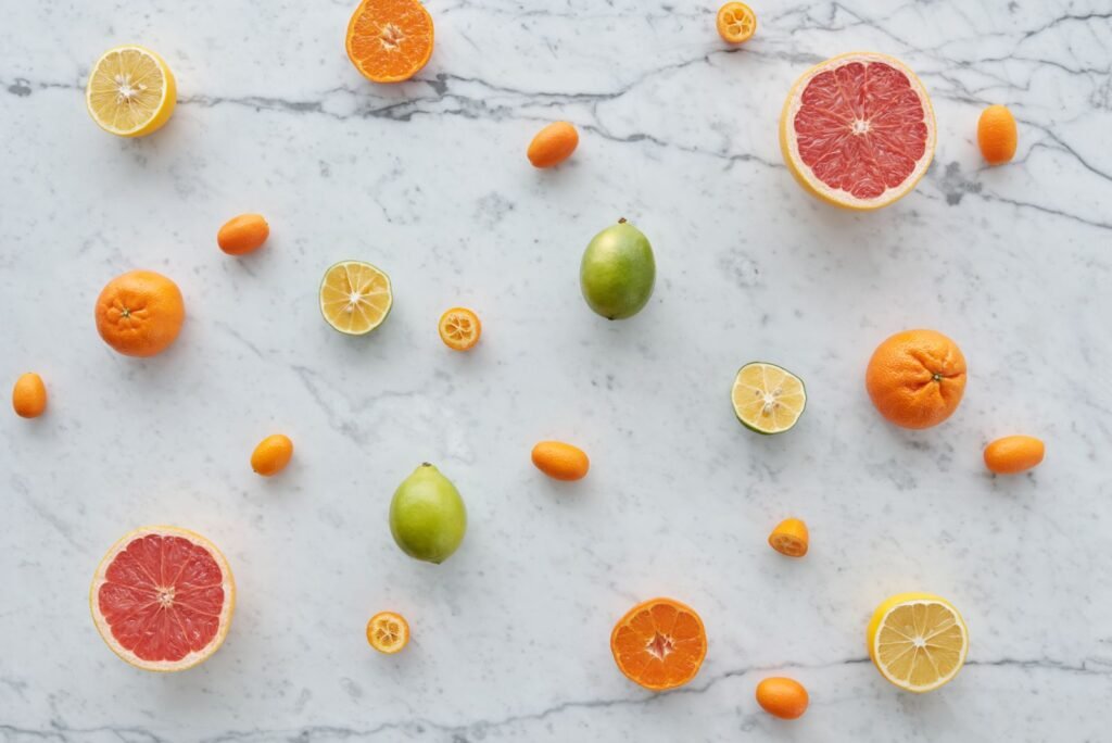 Fruit season chart showing assorted fresh citrus fruits arranged on marble